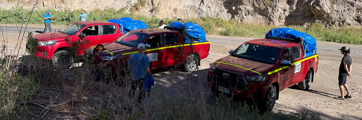 HME guides and 4x4 trucks getting ready for an expedition in the Andes.