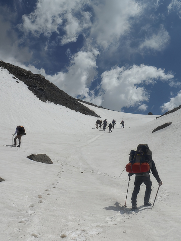 Roped-up mountaineers moving across the crevassed glacier of Marmolejo.