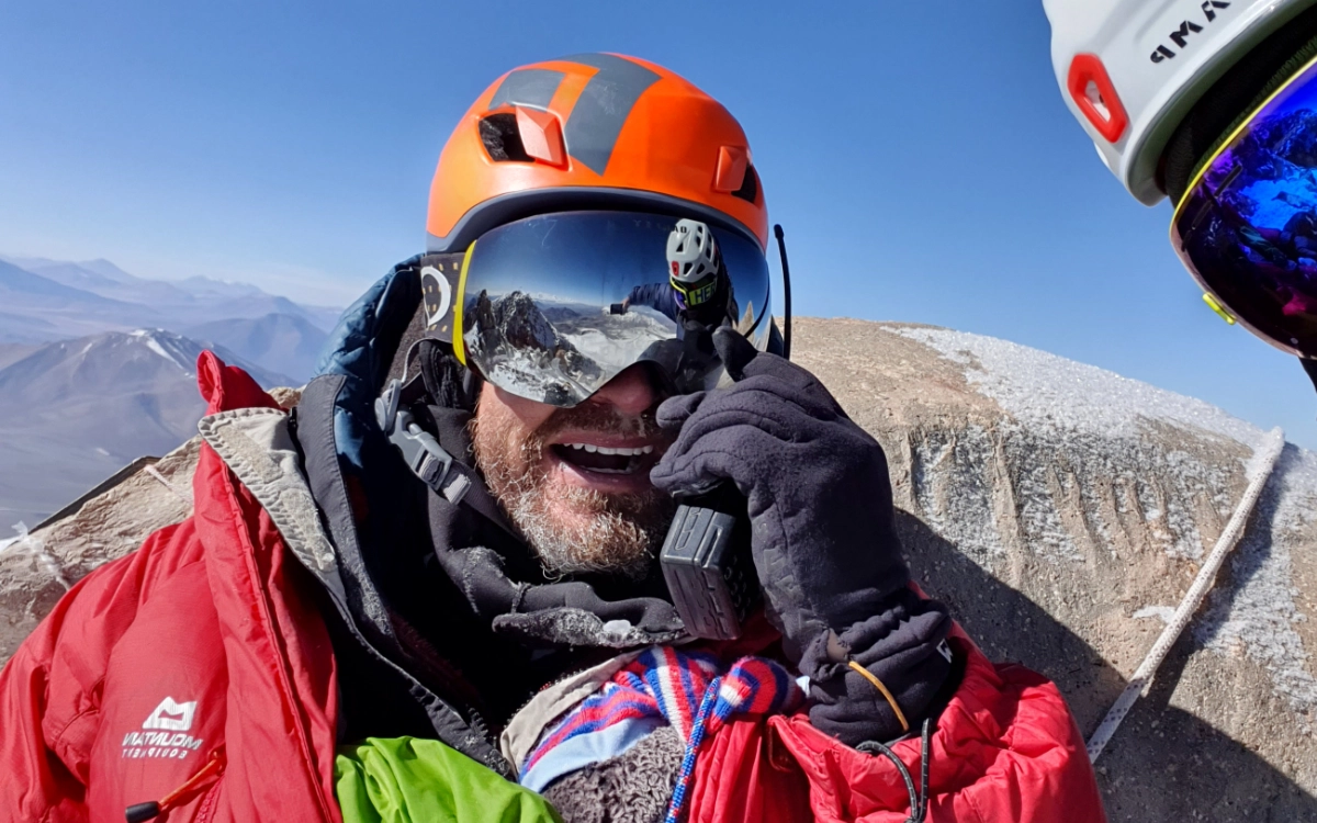 Expedition guide communicating via radio at the summit of Ojos del Salado, the highest active volcano in the world.