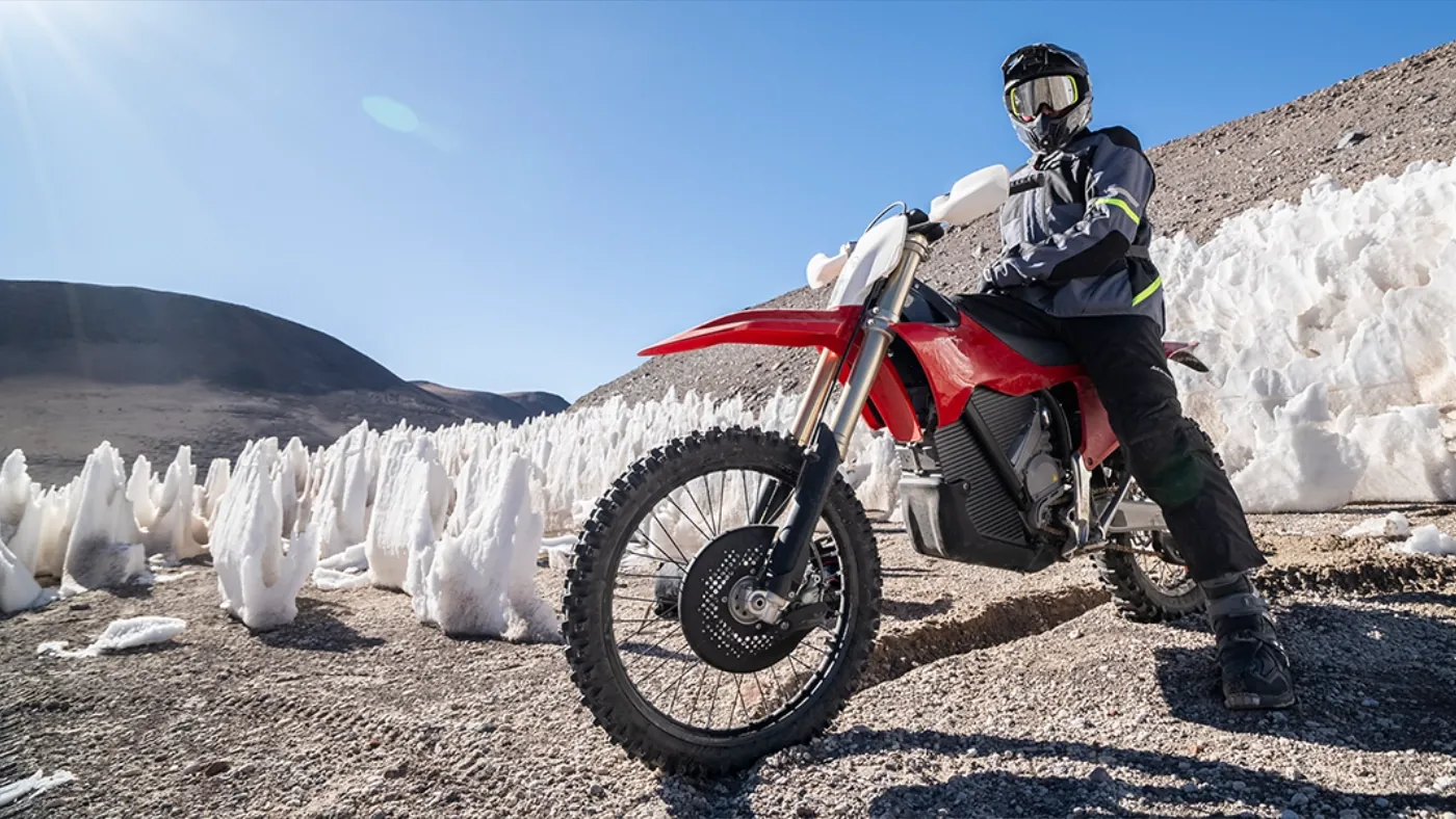 Jiří Žák on the Stark Varg EX electric motorcycle among penitentes